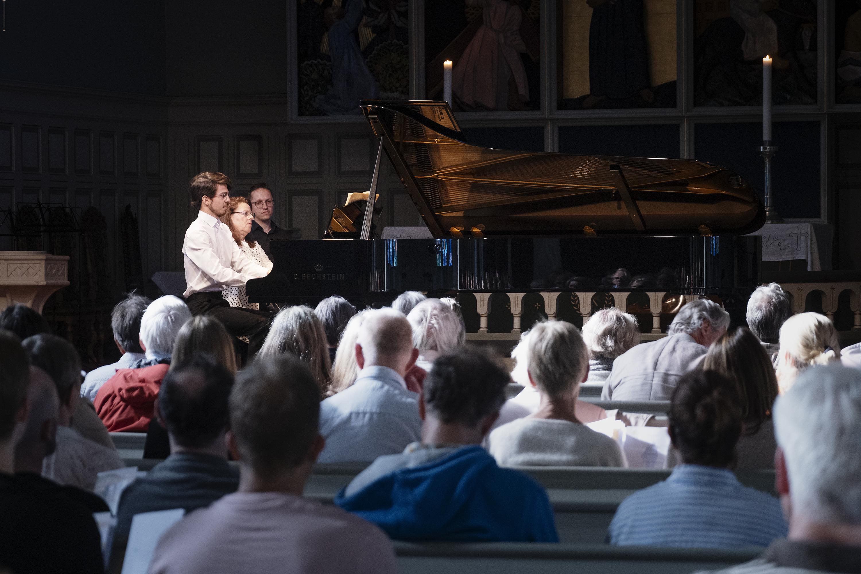 At the piano, profile view
